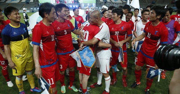 朝鲜与韩国球员在一场友谊赛结束后，拥抱欢庆。