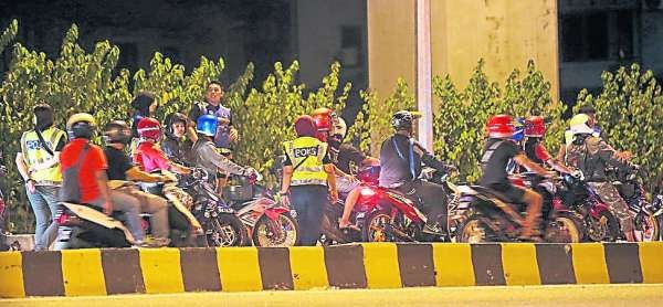 大批警员严正以待，逐一检查路过的摩托车骑士与乘客。