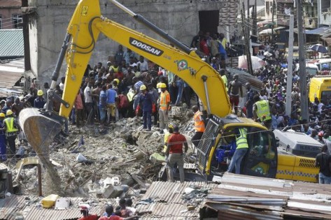 Emergency services attend the scene after a school building collapsed in Lagos, Nigeria, Wednesday March 13, 2019. Rescue efforts are underway in Nigeria after a three-storey school building collapsed while classes were in session, with some scores of children thought to be inside at the time. (AP Photo/Sunday Alamba)