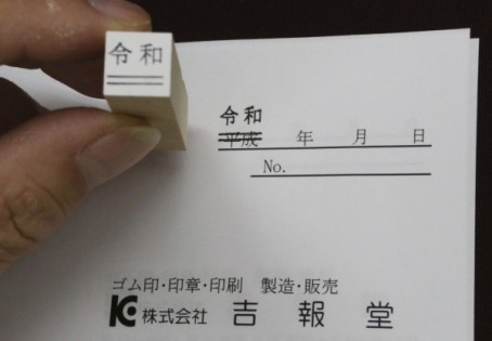日本一些中小企业怕文件上旧年号来不及改，抢刻“令和”图章。（美联社）