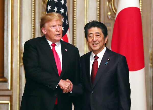 在赤坂离宫迎宾馆，美国总统特朗普（左）星期一和日本首相安倍晋三握手，随后举行工作午餐。（欧新社）