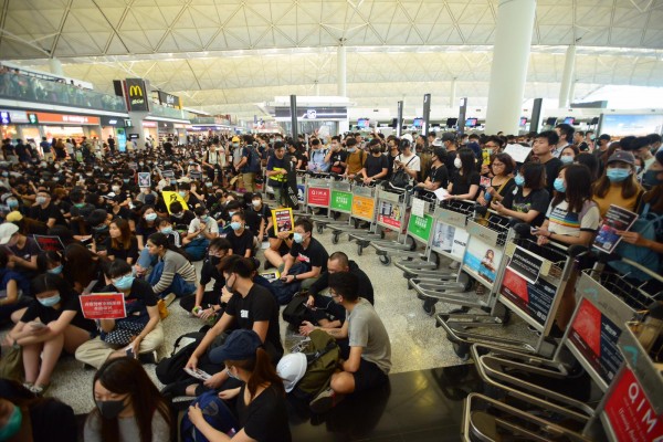 大批身穿黑衣的示威者今日继续在香港机场集结，不满警方执法及政府修例等，堵塞客运大楼离境大堂，机场运作再受影响。机管局宣布，所有航班登记服务暂停。