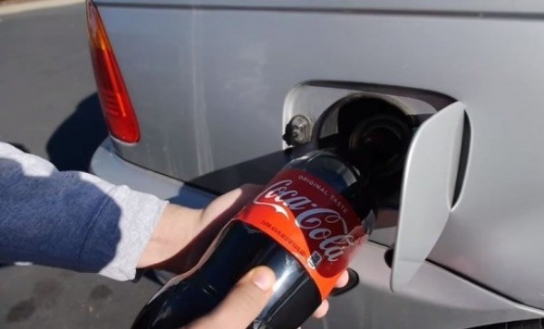 TechRax将一瓶可乐灌进汽车油箱。（网络图）