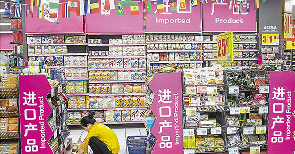 上海一超市店员正对进口货品进行分类。