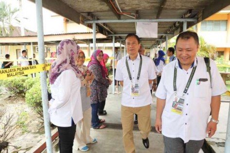 选举委员会主席阿兹哈阿兹占（中）巡视芦骨拉惹祖马安国中投票站。