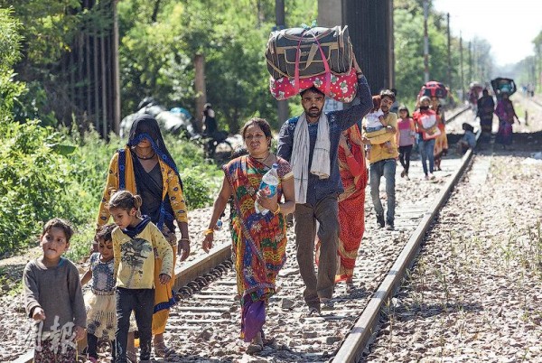 印度新德里前日有大批民工扶老携幼，徒步回乡。（新华社）